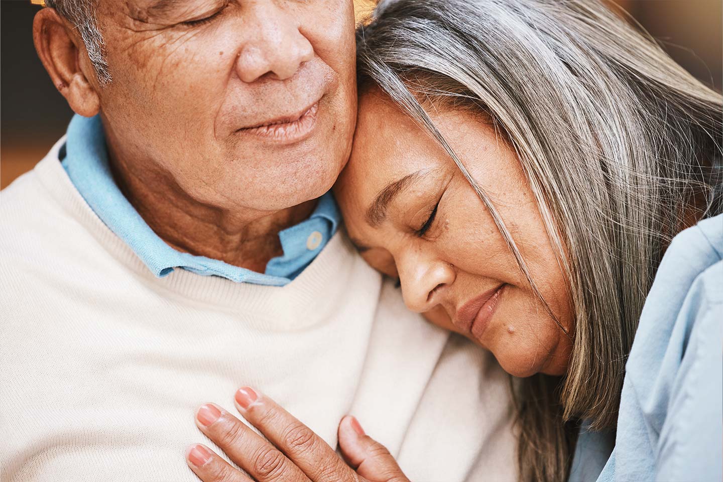 Photo of woman resting her head on a man's shoulder