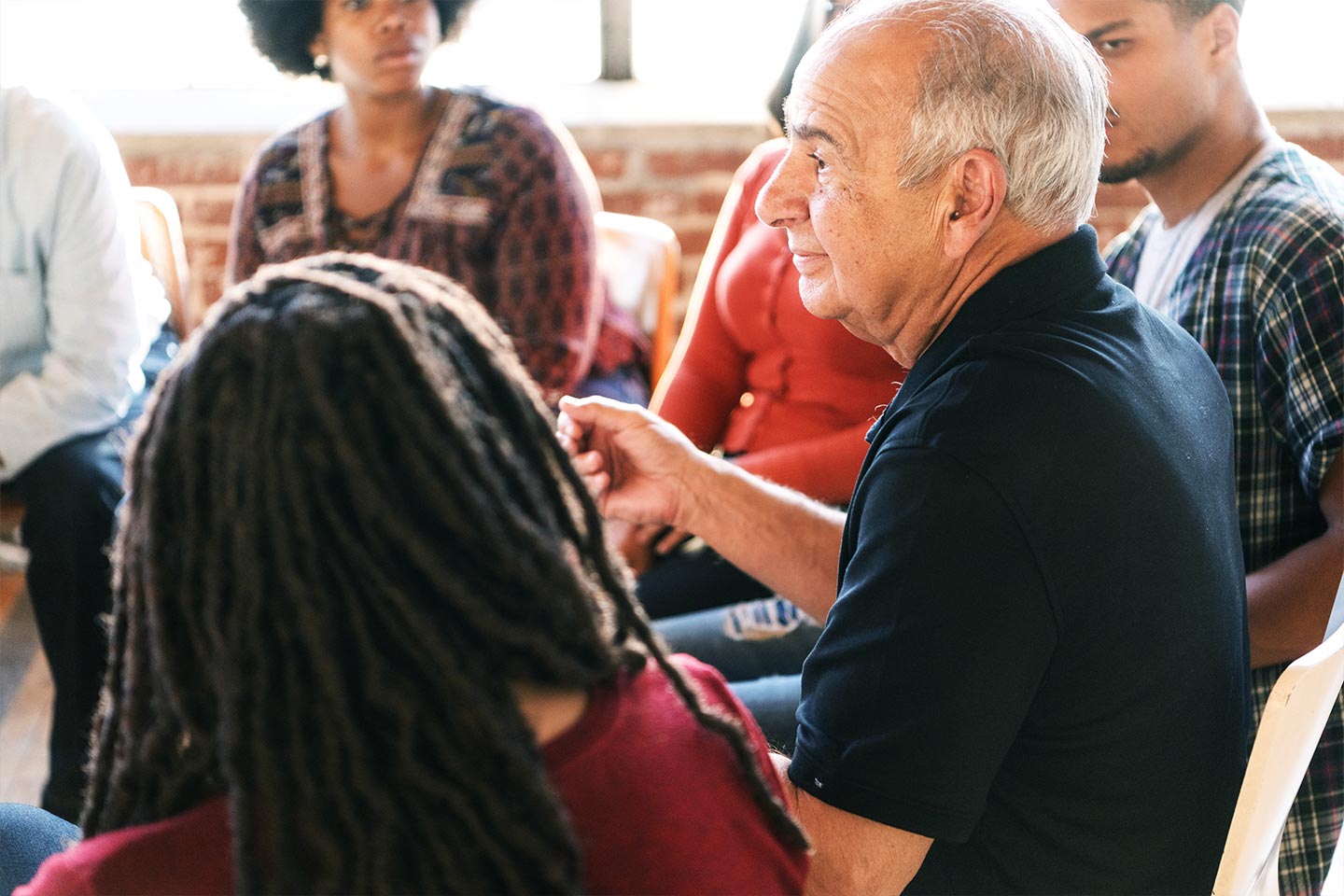 Photo of people sitting in a meeting circle