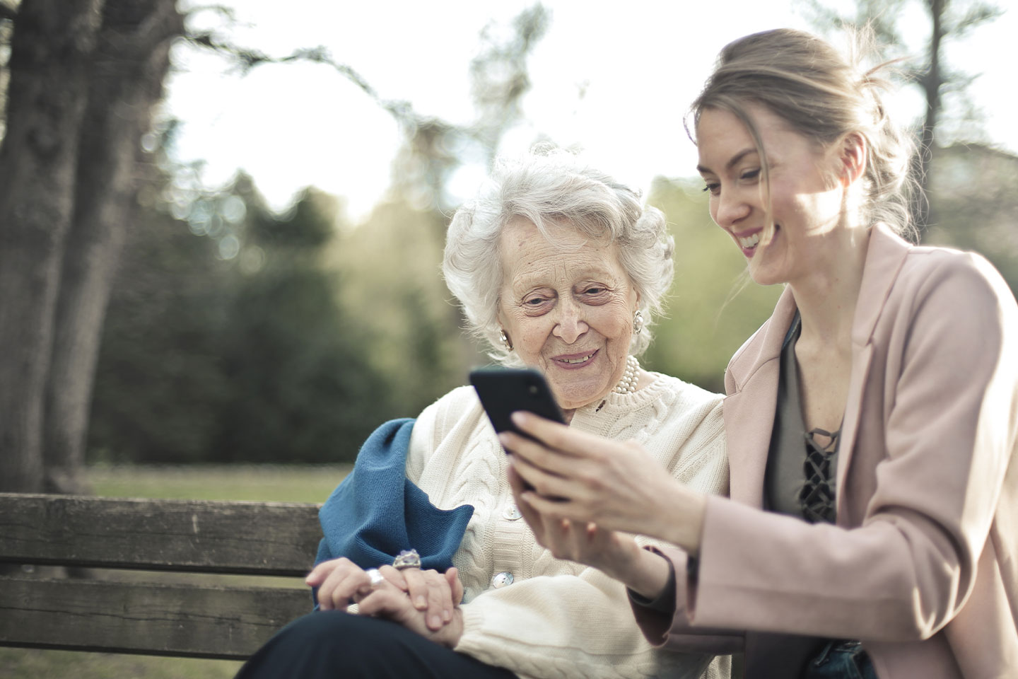 Two women looking at a mobile phone together