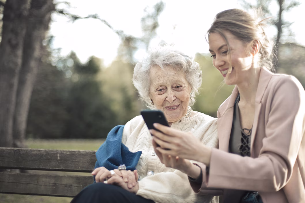 Two women looking at a mobile phone together