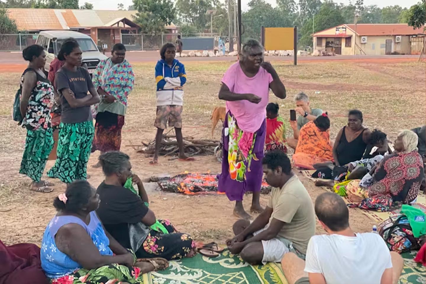 Photo of a group of people sitting together in a country town