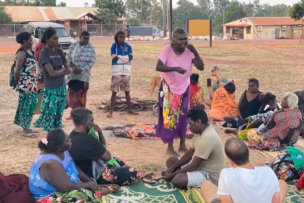 Photo of a group of people sitting together in a country town