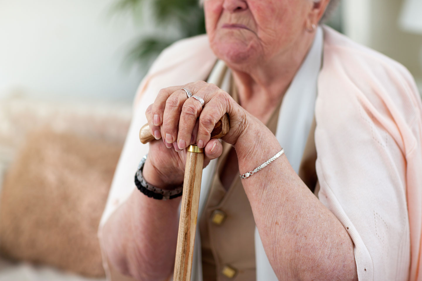 Senior woman's hands on cane