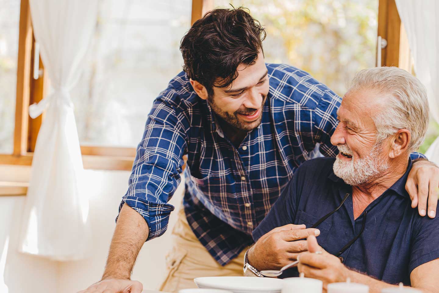 Photo of young man chatting with senior man