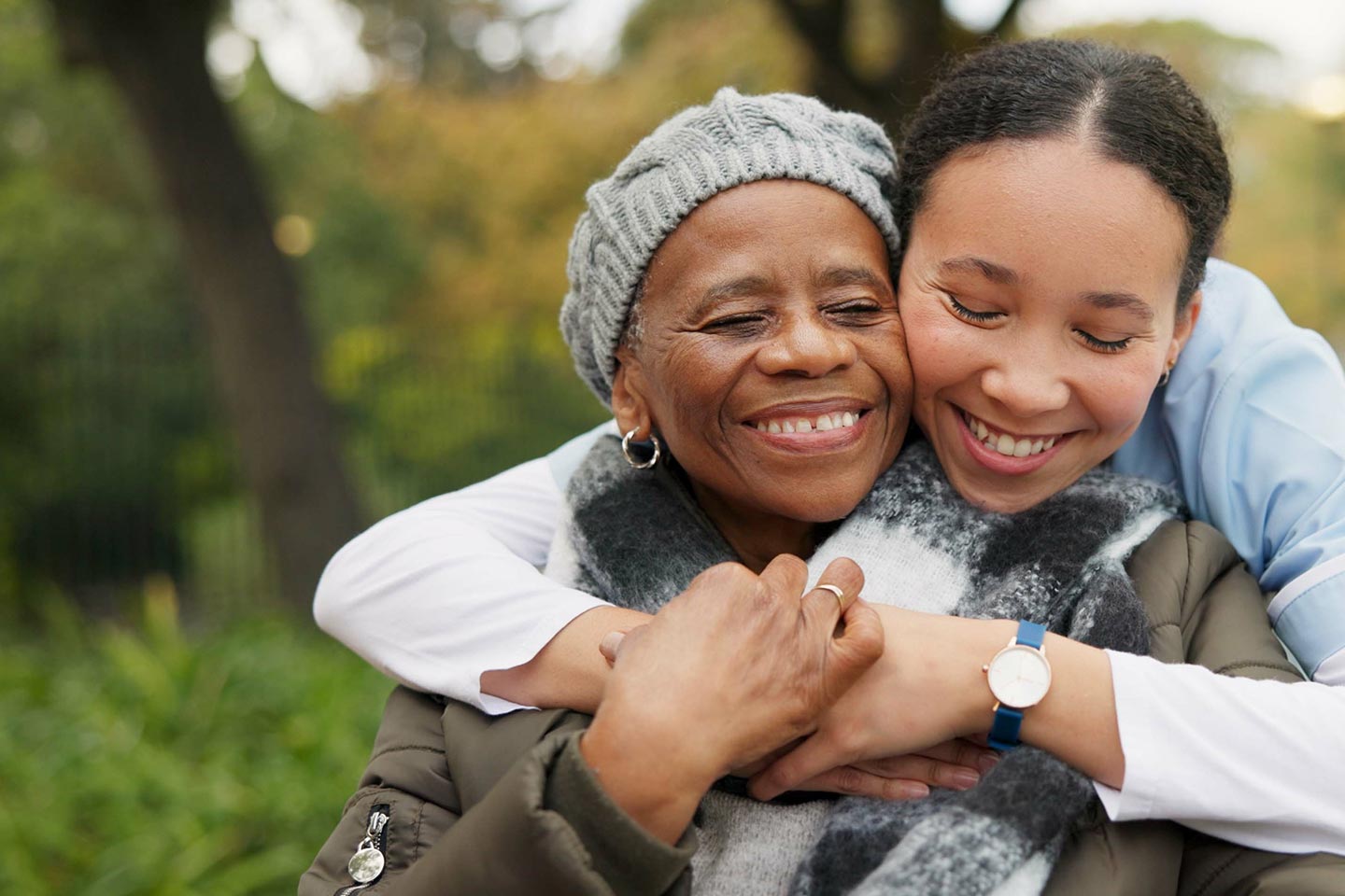 Photo of a woman embracing the shoulders of another woman