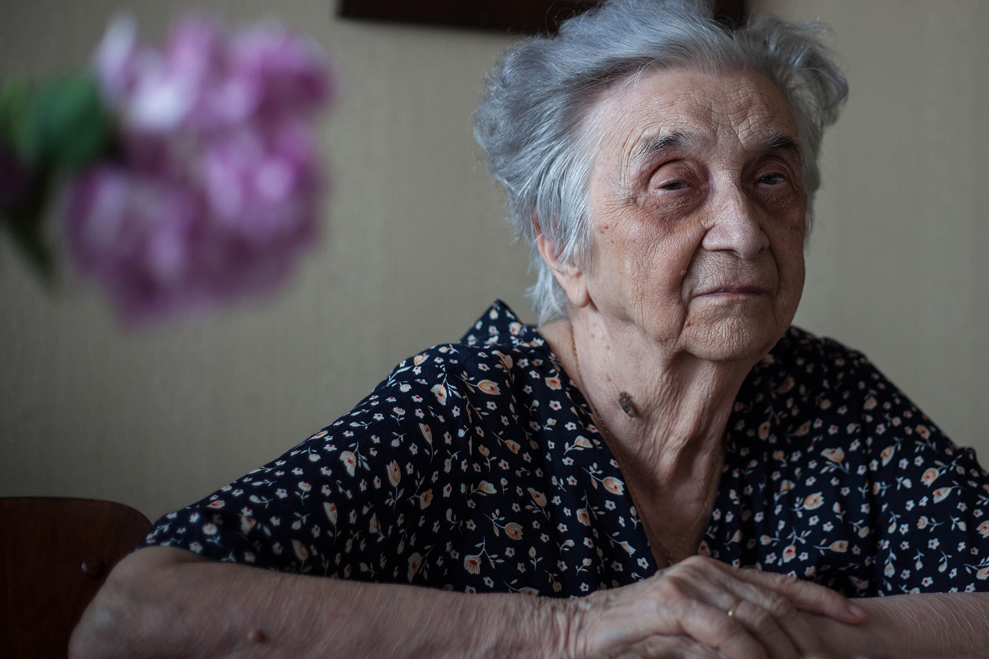 Photo of a woman with blurry flowers in the foreground