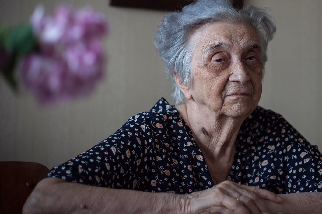 Photo of a woman with blurry flowers in the foreground