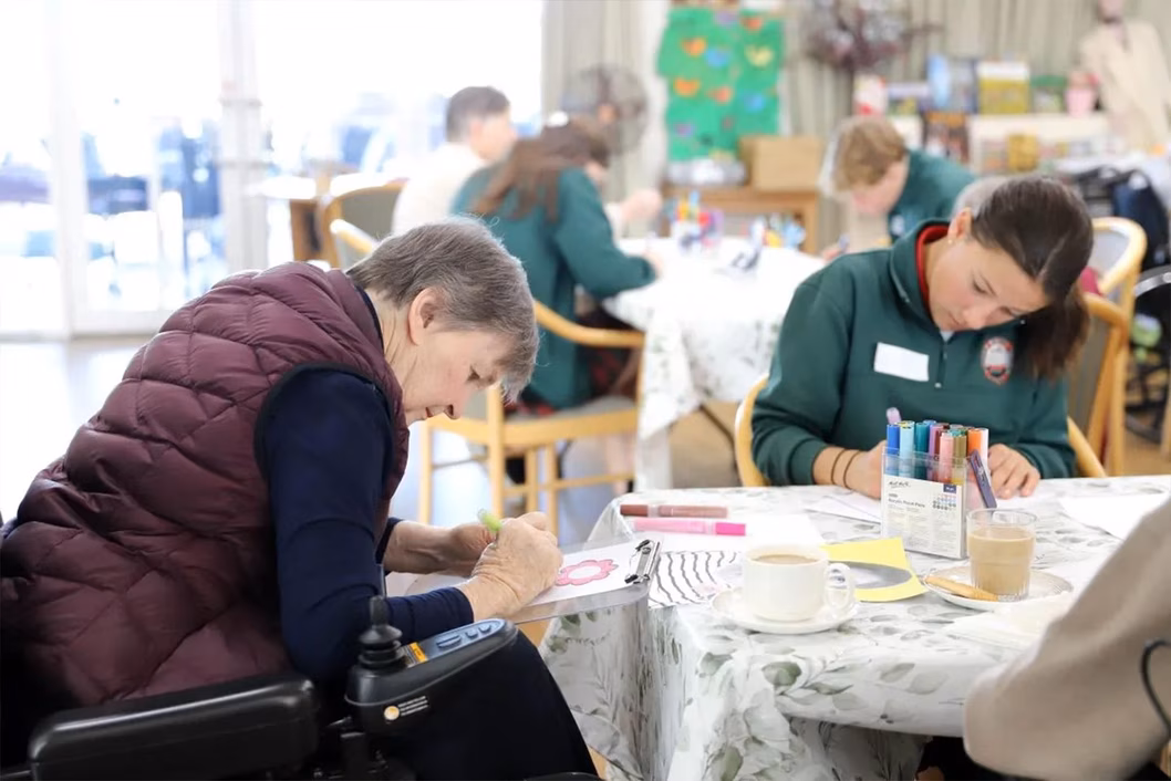 Photo of young and older people crafting together