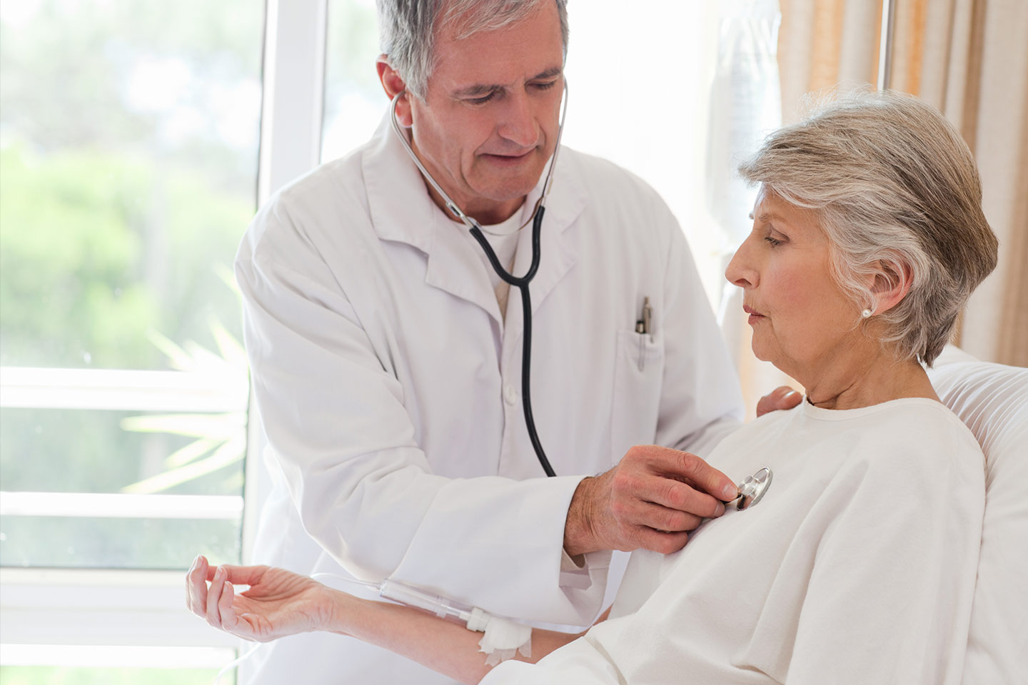 Photo of a doctor checking a patient's heart