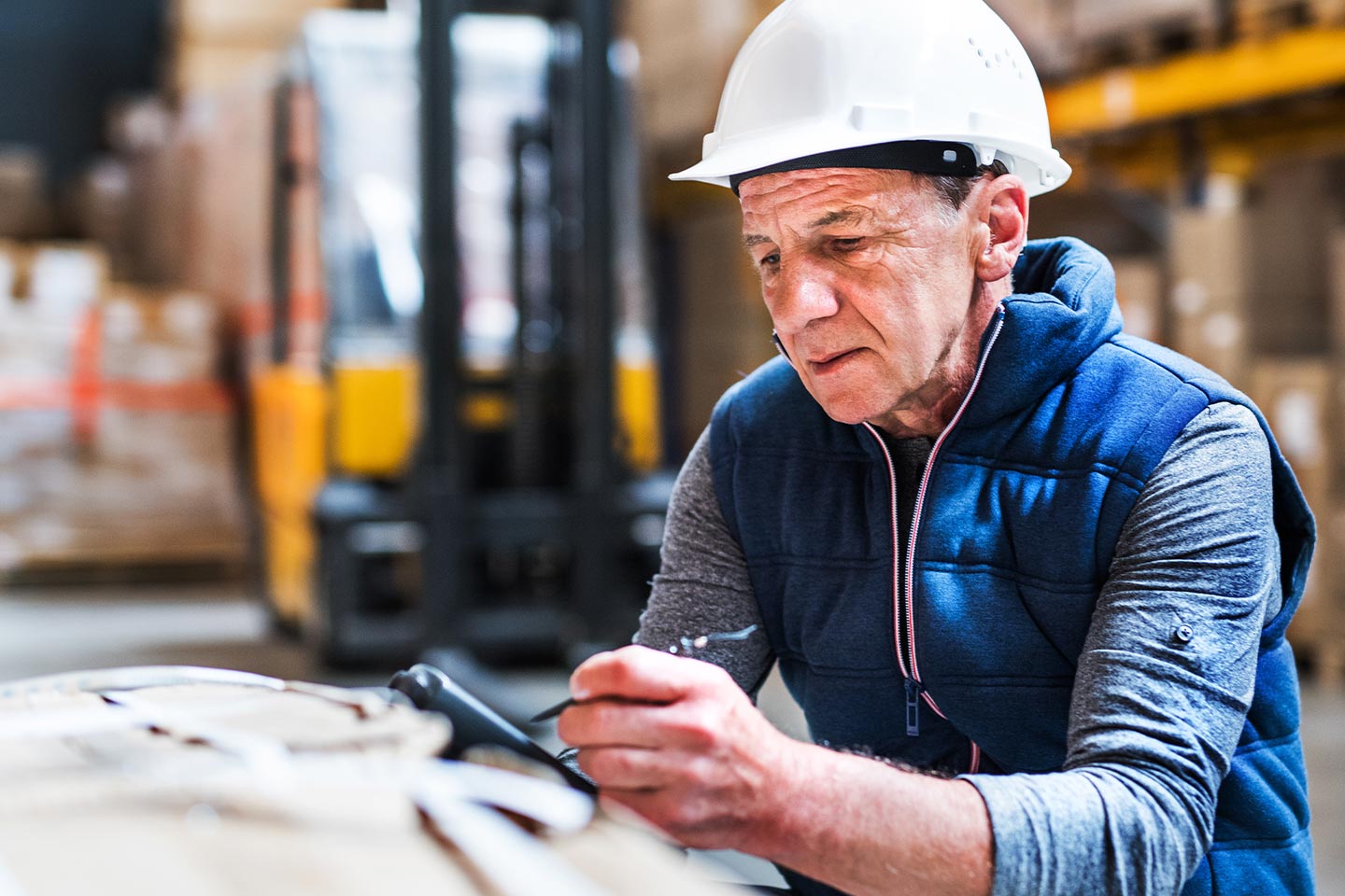 Photo of a man in a hard hat and navy vest