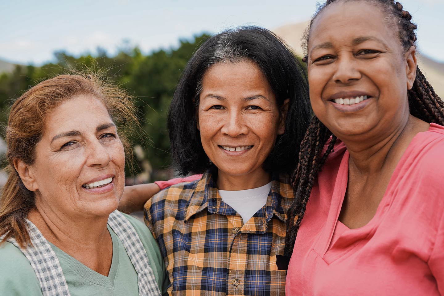 Photo of a diverse trio of smiling women