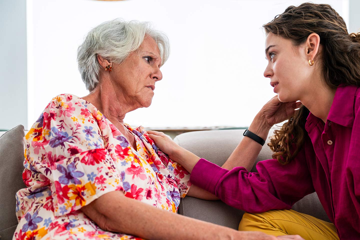 Photo of two women sitting together on a couch