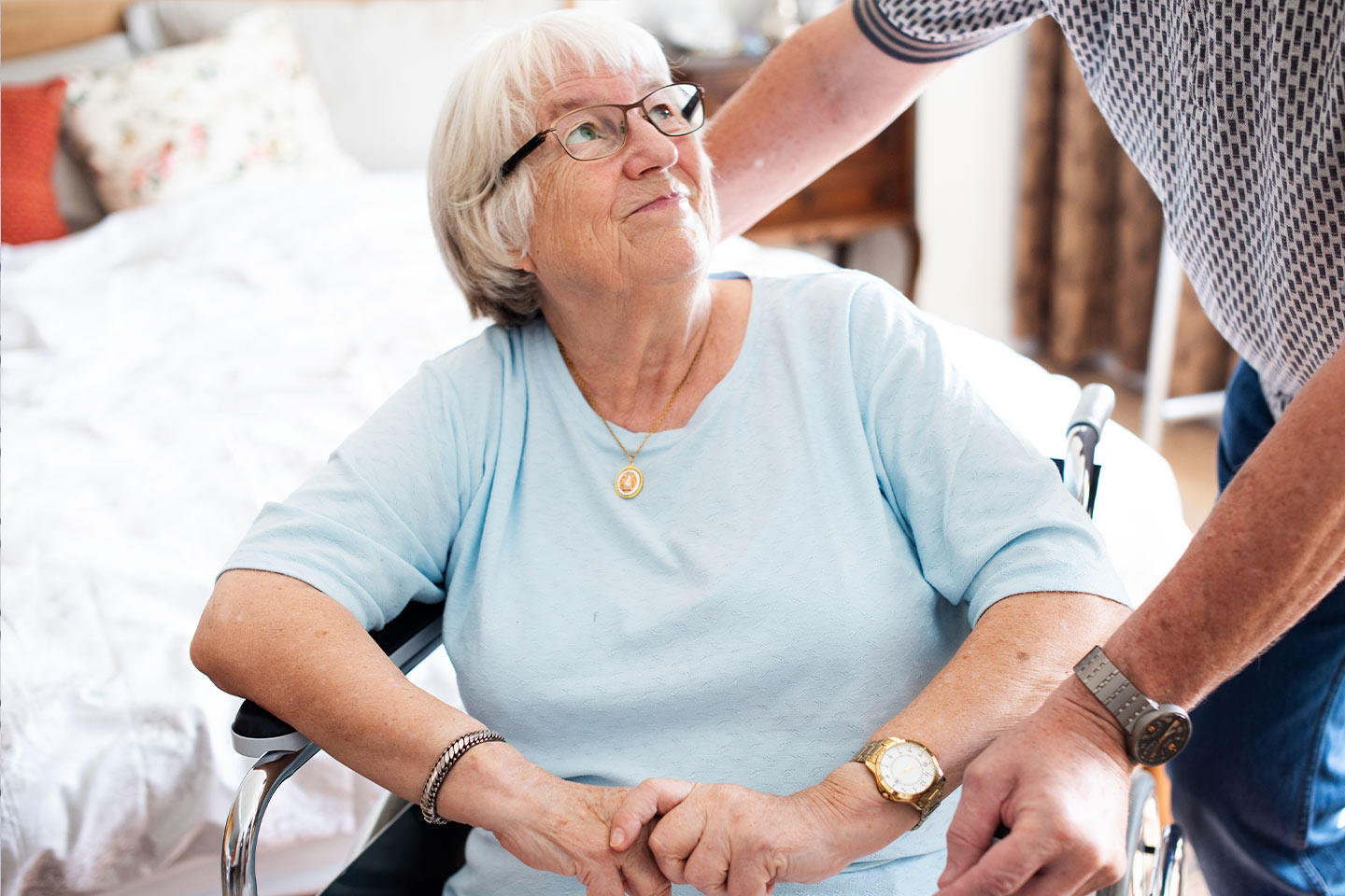 Photo of a woman in a baby blue t-shirt sitting in a wheelchair