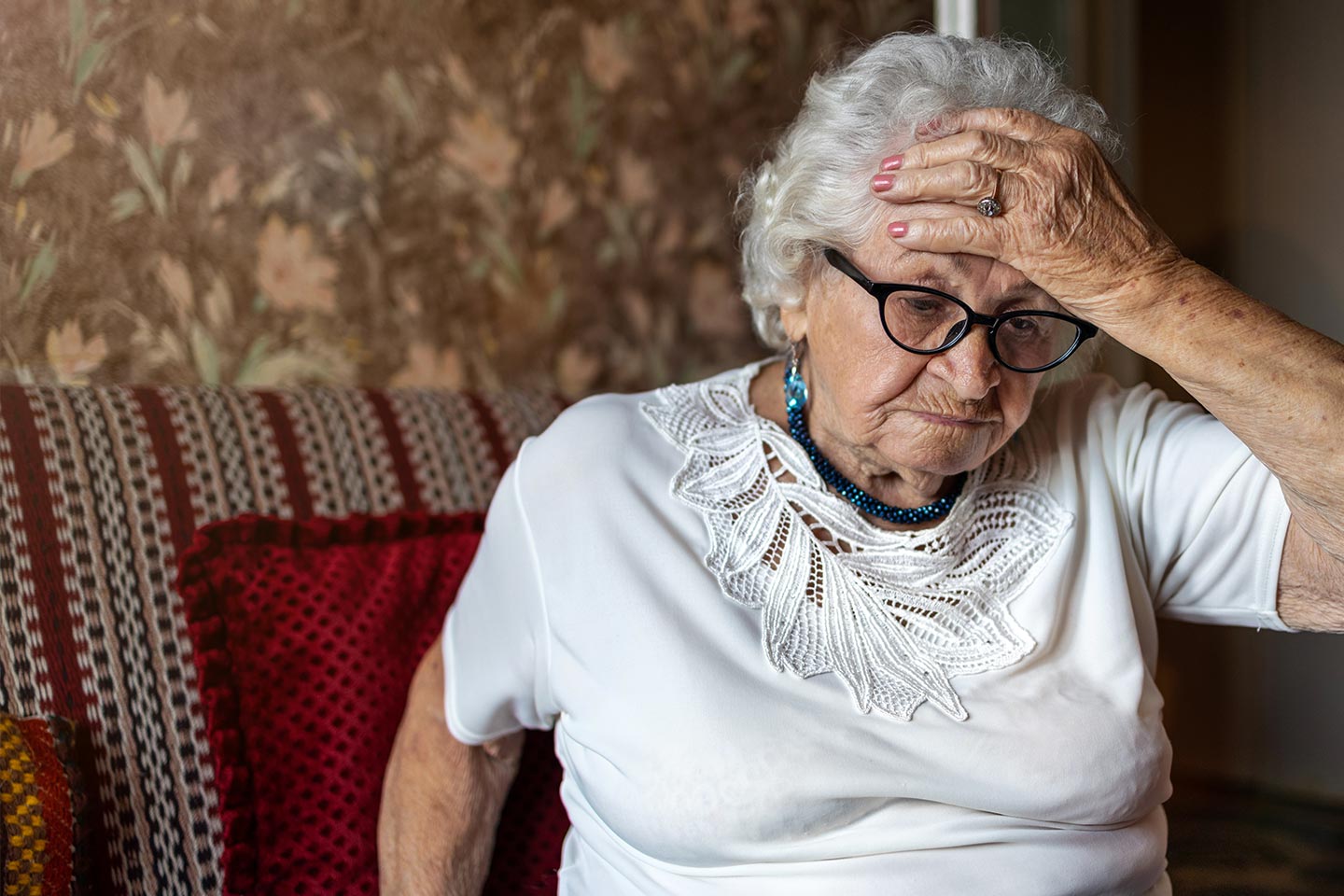 Photo of a woman with her palm cupping her forehead