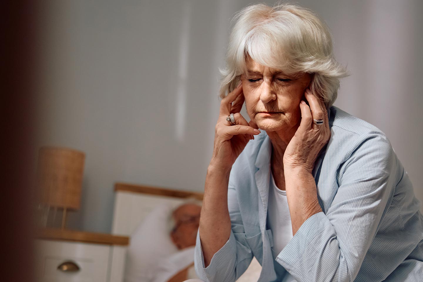 Photo of a woman with white hair and a pale blue jacket