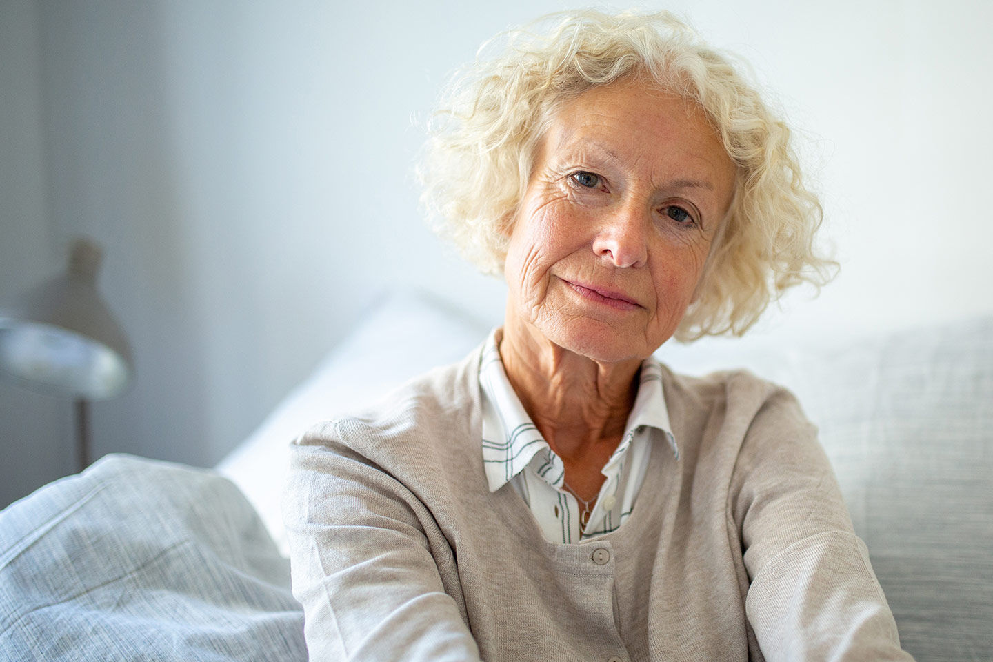 Photo of woman with blonde hair and pale grey top