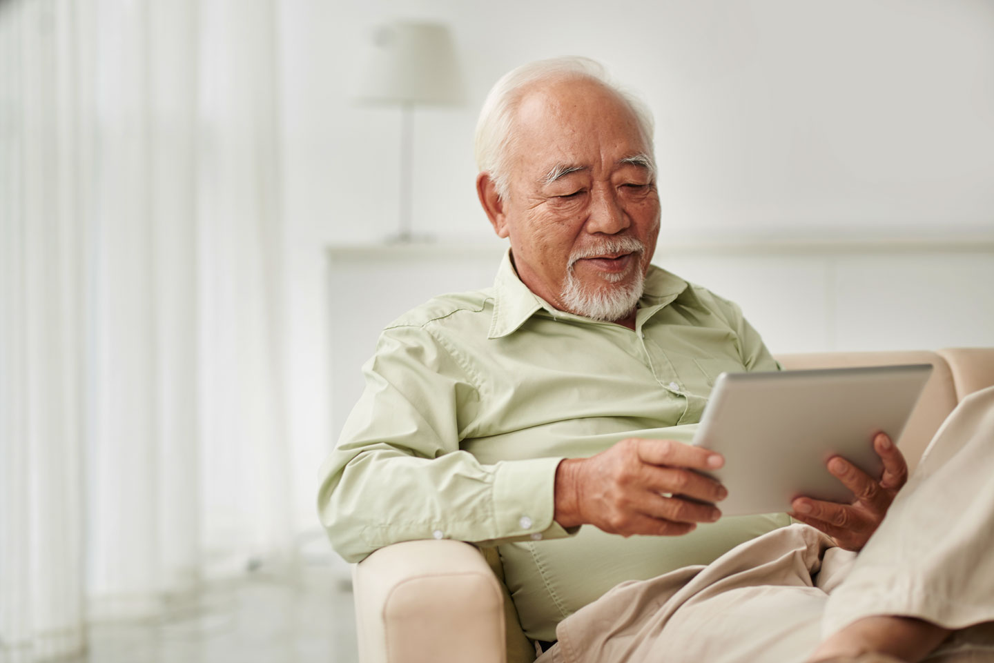 Senior man reading from tablet