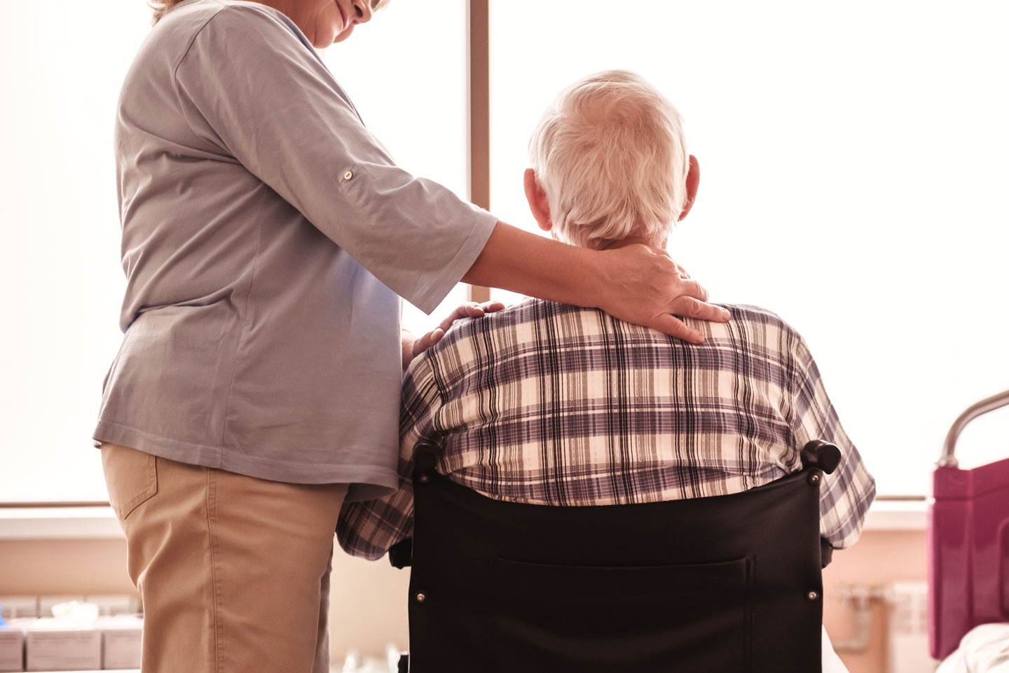 Senior man in wheelchair with wife