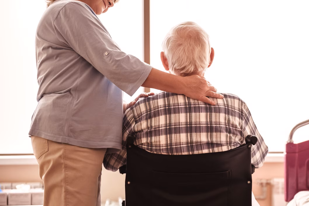 Senior man in wheelchair with wife