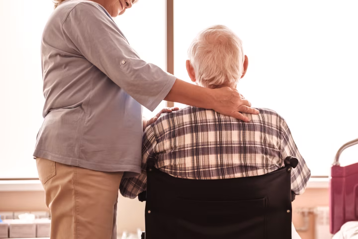 Senior man in wheelchair with wife