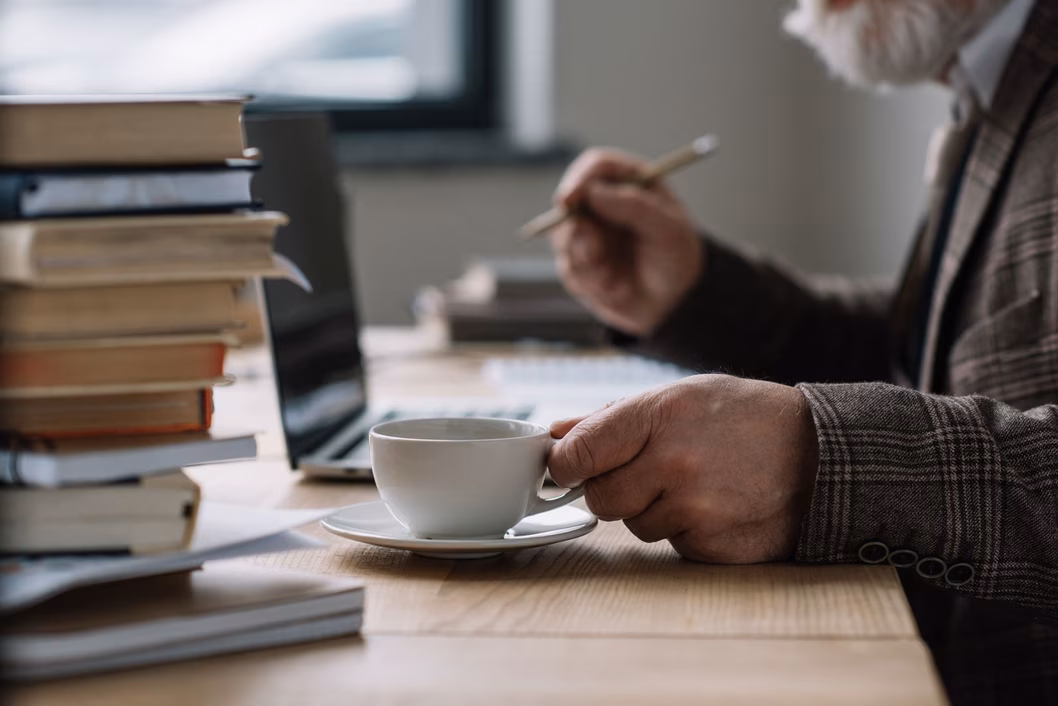 Senior man working and drinking coffee
