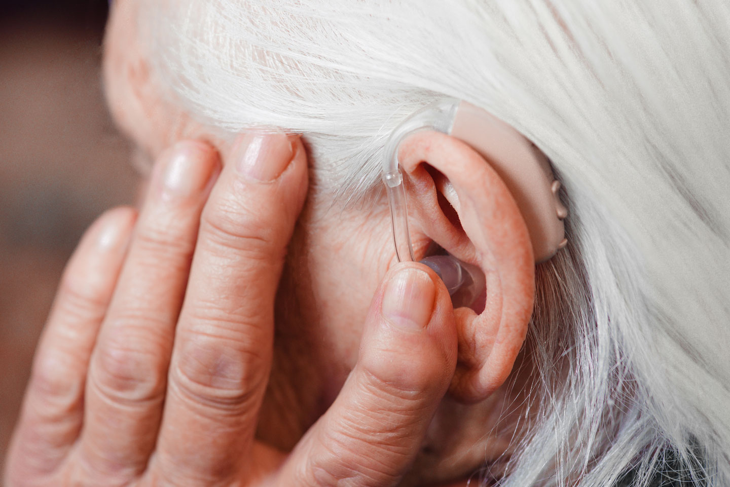 Older womans hearing aid