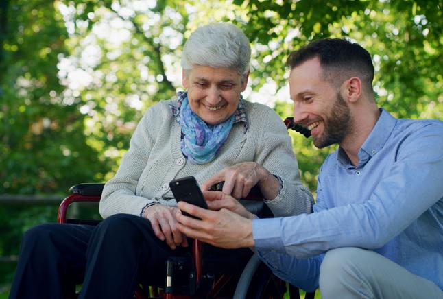 Senior woman in wheelchair with her adult son 