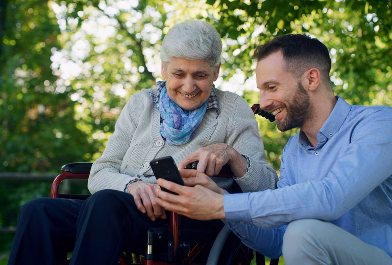 Senior woman in wheelchair with her adult son 