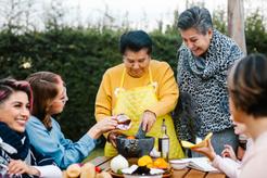 intergenerational family cooking in the garden