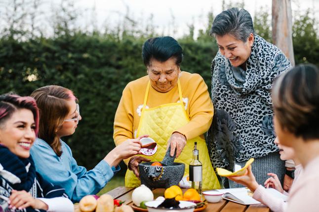 intergenerational family cooking in the garden