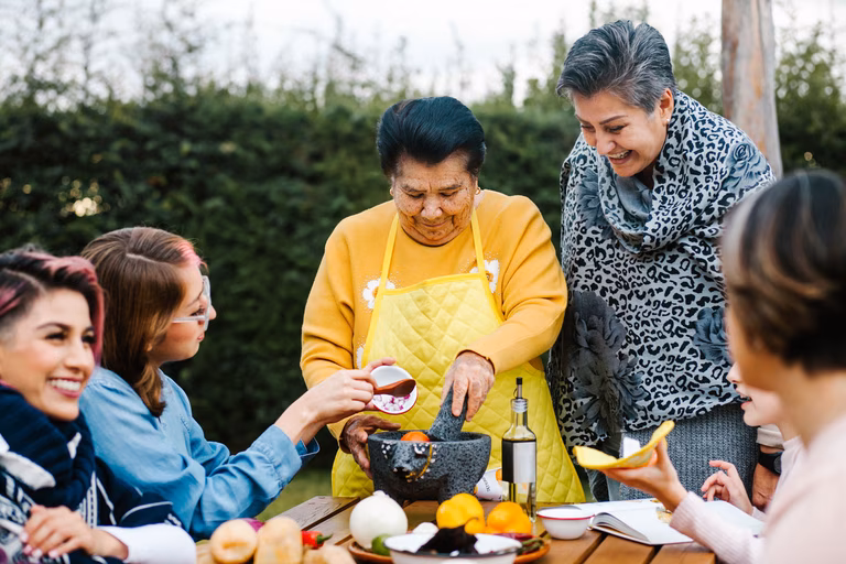 intergenerational family cooking in the garden