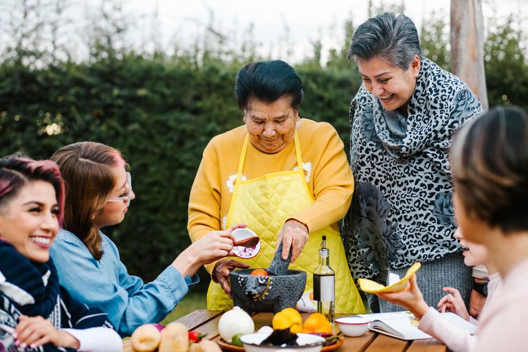 intergenerational family cooking in the garden