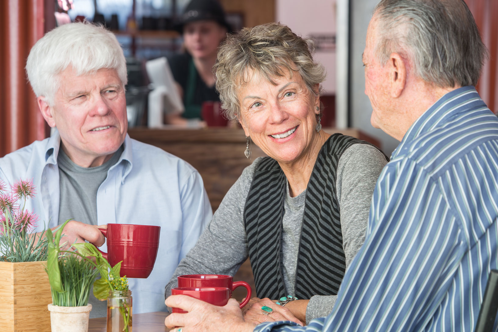 Three senior friends at a cafe
