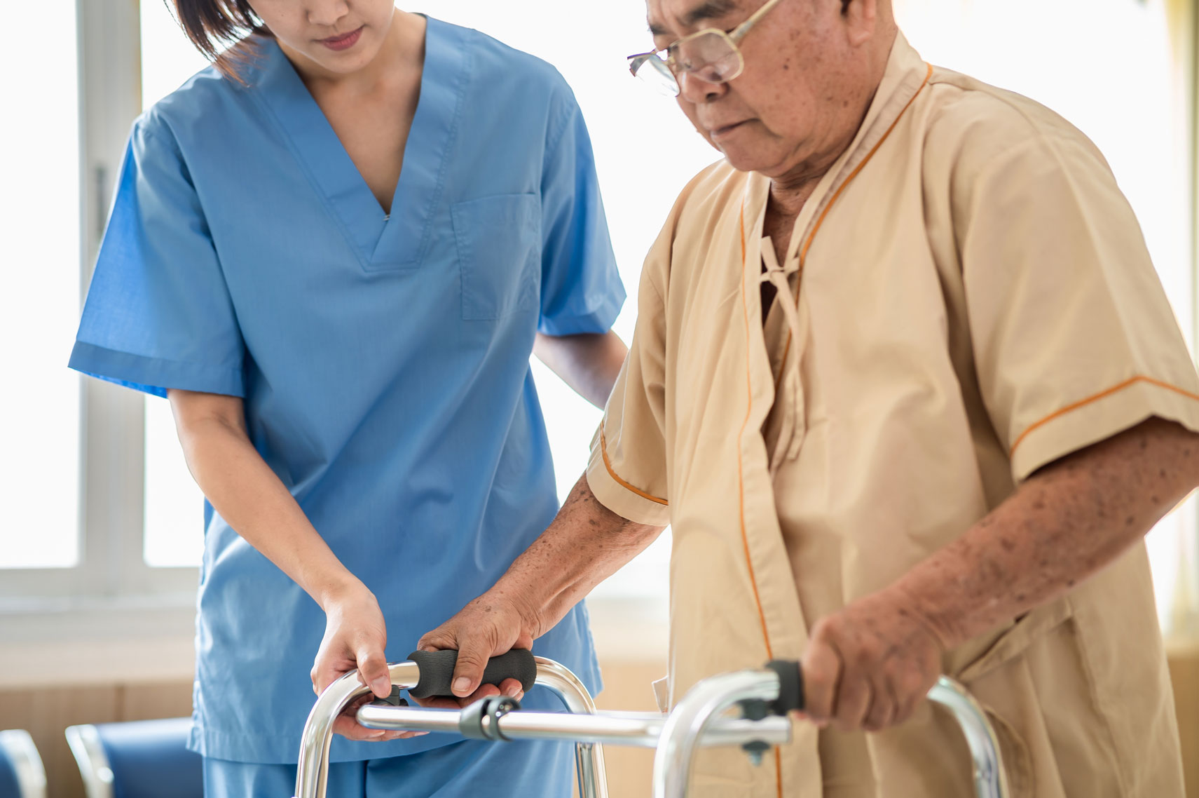 Aged care worker helping senior man