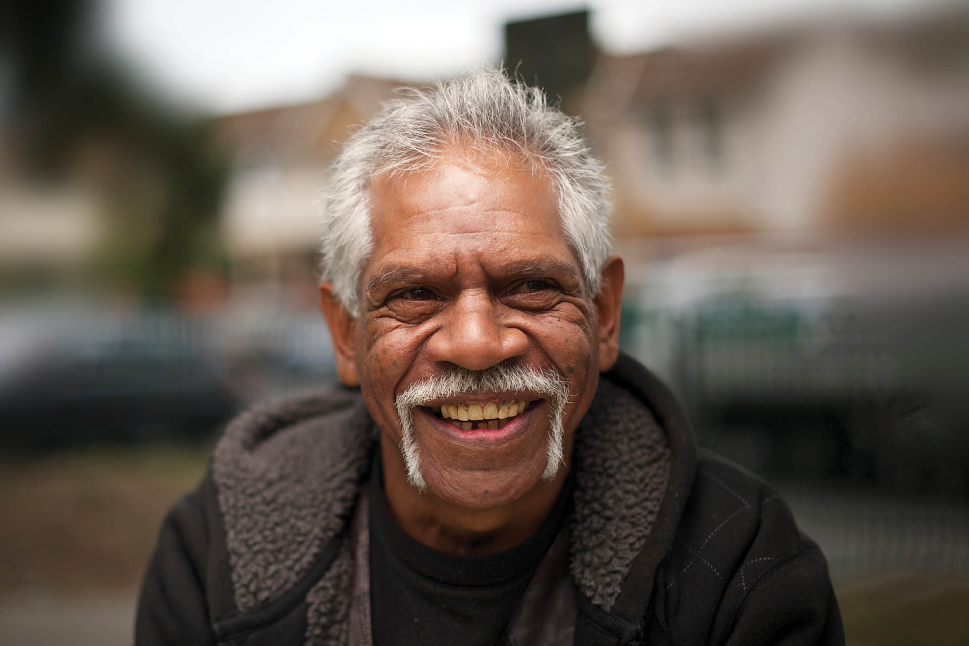 Image of an Aboriginal man with a grey moustache and hair