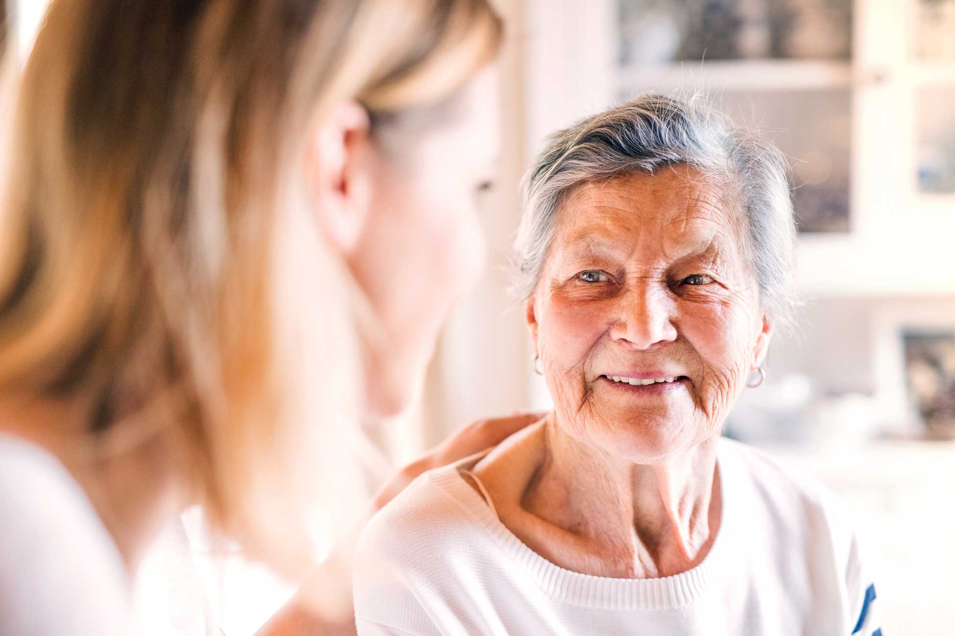 Senior woman talking with adult daughter