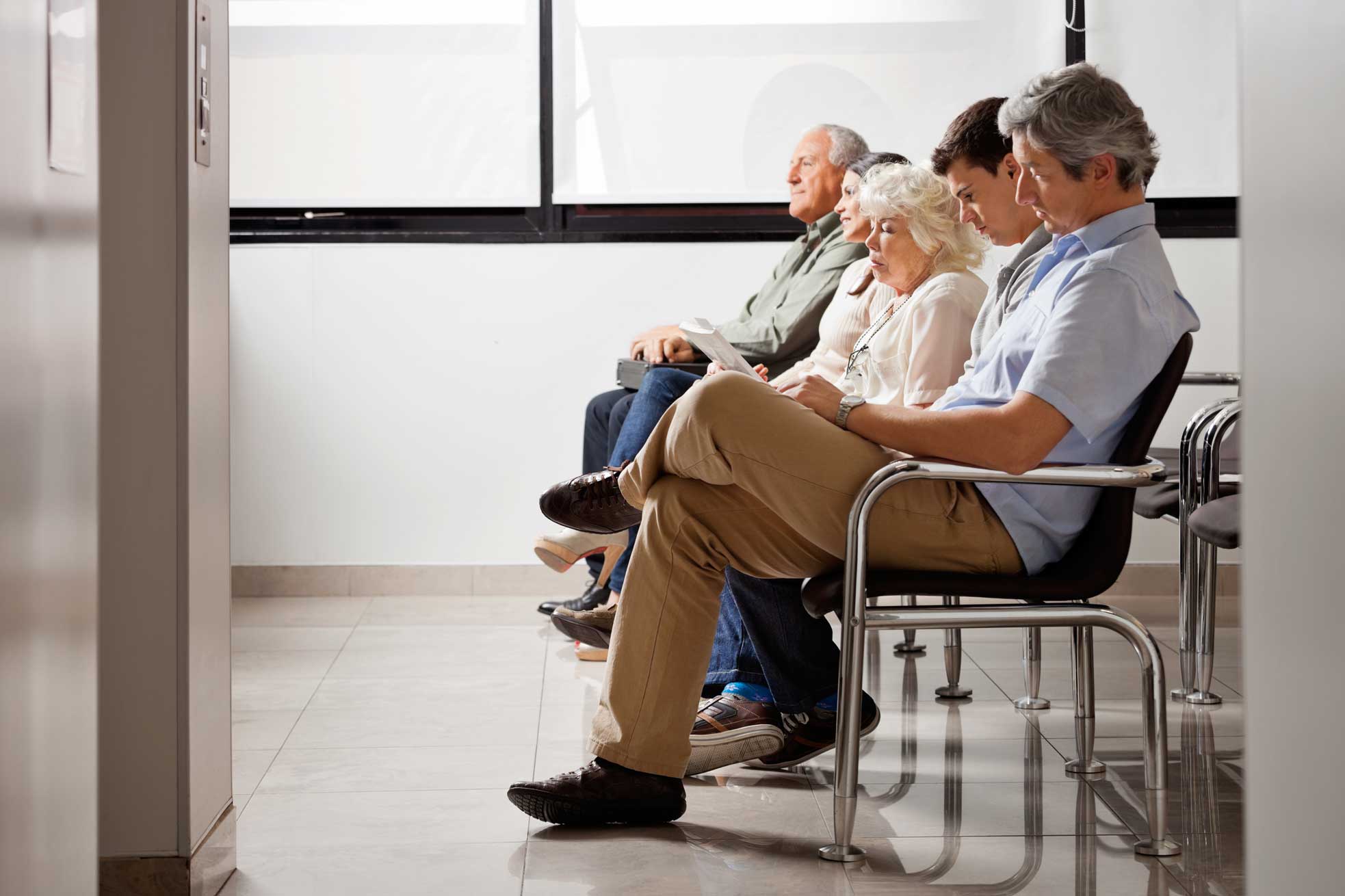 Compass image of older people sitting in a waiting room