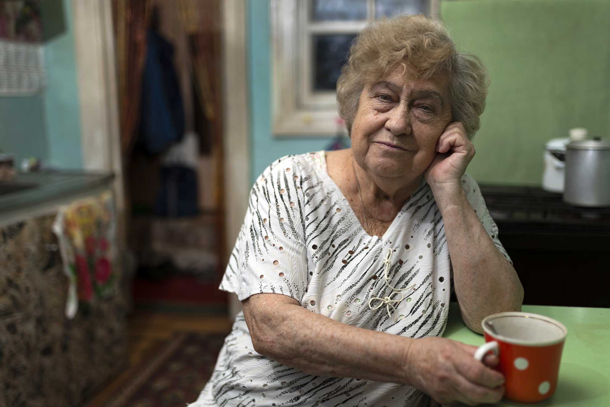 Compass image of an older women drinking coffee