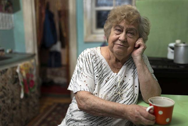 Compass image of an older women drinking coffee