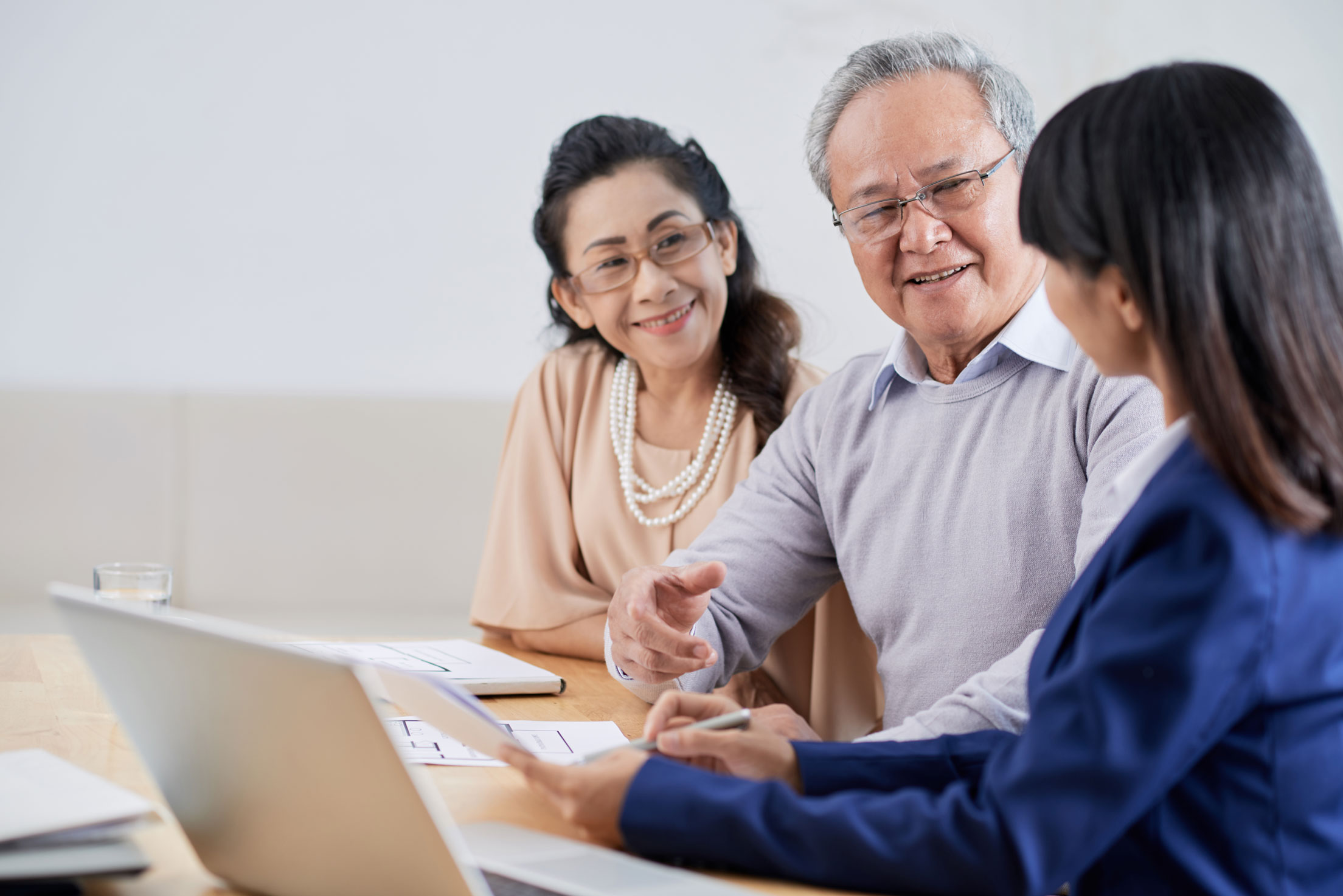 Senior couple talking to professional woman