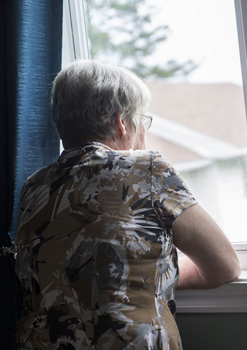 Senior woman looking out of the window