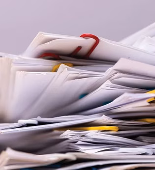 Photo of a messy stack of papers and paper clips in closeup