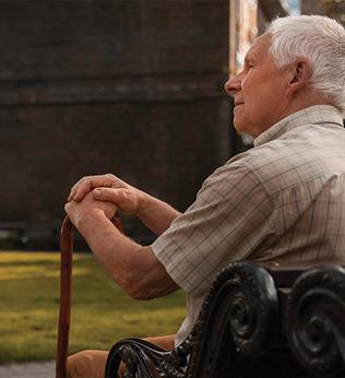Photo of a man sitting on a park bench
