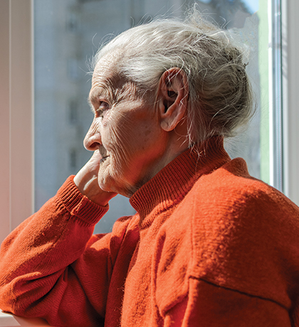 Photo of a senior lady in an orange jumper