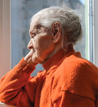Photo of a senior lady in an orange jumper