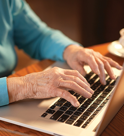 Photo of hands on a laptop keyboard