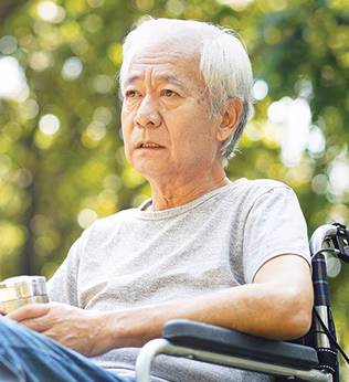Photo of a sad looking man sitting in a wheelchair