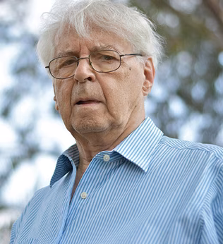 Photo of man wearing glasses and a blue striped shirt