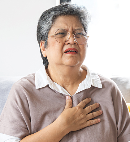 Photo of a woman in a mauve top looking anguished