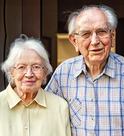 Photo of an older couple smiling at the camera